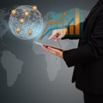 businessman holding a tablet showing business graph on virtual screen